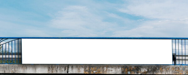 Long white vinyl banner fixed on metal bridge handrail outdoor. Public commercial advertising...