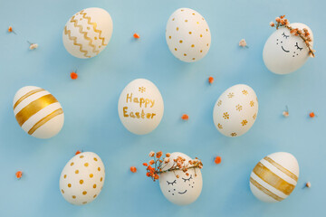 Easter background. Easter golden decorated eggs on blue background. Minimal easter concept. Flat Lay of Golden Easter Eggs