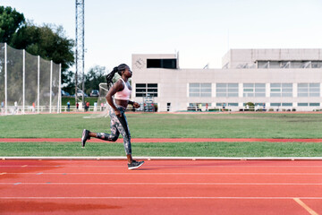 Fototapeta premium Athlete woman sprinter running in track