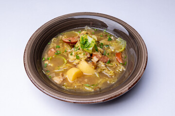 Slovak soup from sauerkraut, potatoes and smoked meat