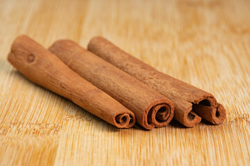 Cinnamon sticks on a wooden background. Fragrant cinnamon seasoning close-up. Spices with cinnamon. Food cooking video concept. ingredients for warm wine, mulled wine
