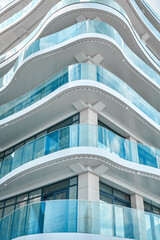 Light blue glass fences on fashionable hotel terraces at popular resort. Stylish multistory...