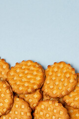 Molded wheat cookies on  blue plain surface whith copy space. Food  backdrop  with wheat biscuits or waffles