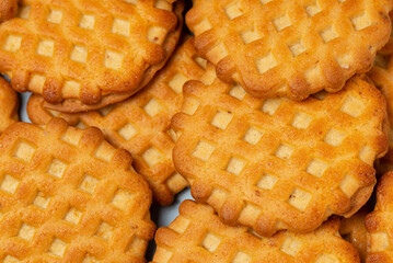 Molded wheat cookies texture close up. Food  backdrop  with wheat biscuits or waffles