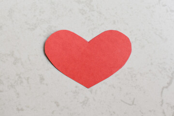 Paper cut red heart shapes on off white background in Pune India
