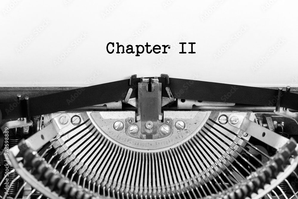 Fototapete chapter two phrase closeup being typing and centered on a sheet of paper on old vintage typewriter m