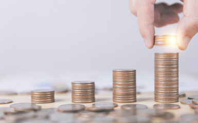 Businessman putting coins. Financial concept of bank account savings	