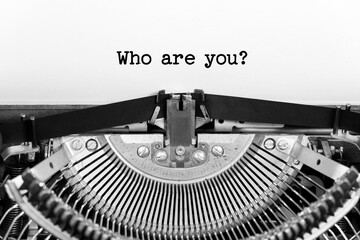 Who Are You phrase closeup being typing and centered on a sheet of paper on old vintage typewriter mechanical - obrazy, fototapety, plakaty
