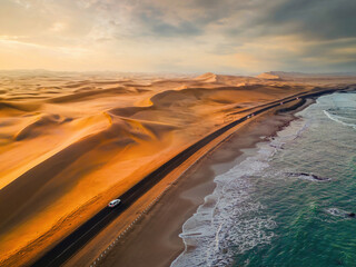 Aerial top view of street road with Namib Desert Safari, sand dune, coast sea in Namibia, South...