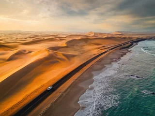Deurstickers Aerial top view of street road with Namib Desert Safari, sand dune, coast sea in Namibia, South Africa. Natural landscape background at sunset. Famous tourist attraction. Sand in Grand Canyon © tampatra