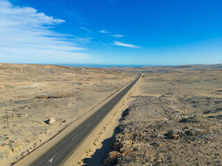 Aerial top view of street road Namib Desert Safari with sand dune in Namibia, South Africa. Natural landscape background at sunset. Famous tourist attraction. Sand in Grand Canyon