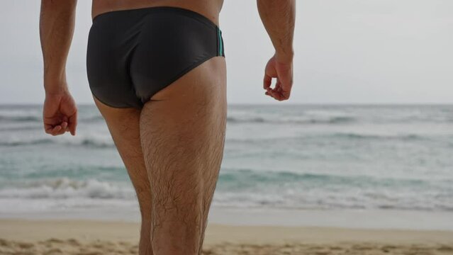 A Beautiful Landscape, a Deserted Beach, far away a Handsome Naked Man Approaches the Ocean and Dives into the Water, Slow motion