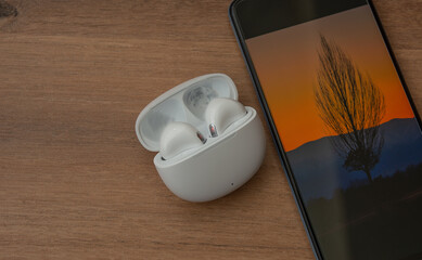 Wireless headphones on a wooden background.