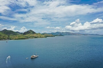 Idlillic panorama shot from the top of the hill of Kalor Island in Komodo National Park on Flores, in the foreground the sea, on the left hills.