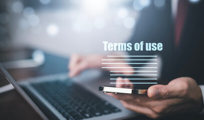 Naklejka premium Businessmen hold smartphone of Terms of use concept, online banking check budget planning concept banner for website header design, Terms of use business concept. Terms and conditions of contract.