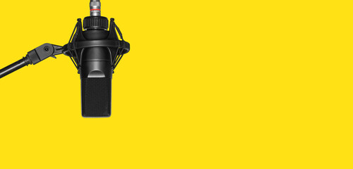 professional microphone isolated on yellow background