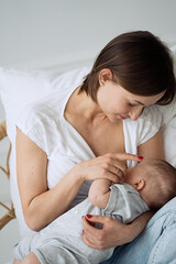 Obraz na płótnie Canvas Mother breastfeeding her newborn baby