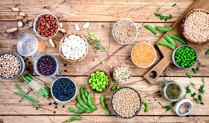 Legumes, beans and sprouts. Dried, raw and fresh, top view. Lentils, mung beans, chickpeas, soybeans, edamame, peas, Healthy diet food, vegan proetin, micronutrients and fiber sources
