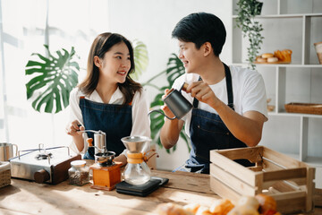 Cute couple, male and female barista working in coffee shop Barista working at cafe Alternative ways of brewing coffee.    .