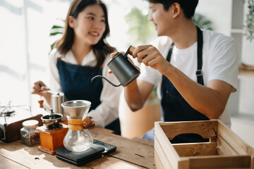 Cute couple, male and female barista working in coffee shop Barista working at cafe Alternative ways of brewing coffee.    .