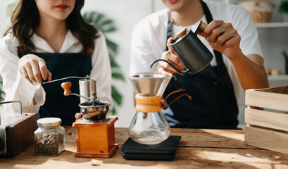 Cute couple, male and female barista working in coffee shop Barista working at cafe Alternative ways of brewing coffee.    .