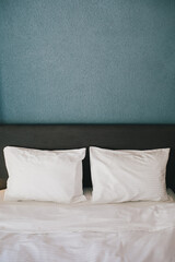 Bed and white linens in a hotel room.