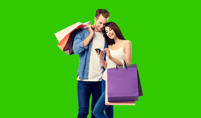 Love, holiday sales, shop, retail, consumer concept - happy couple holding shopping bags, looking...
