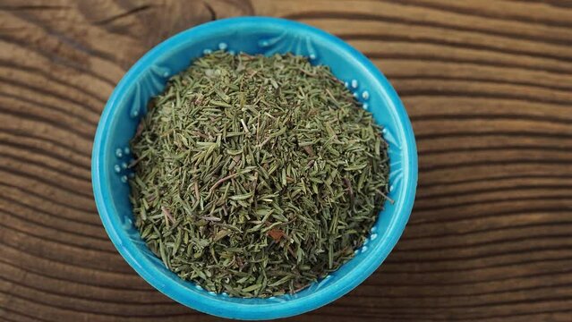 Dry thyme for food in a small bowl on the table