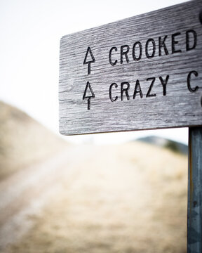 A sign reading crooked and crazy this way on Mount Sentinel