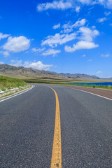 Asphalt road with mountain natural scenery in Xinjiang, China.