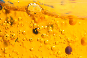 Color cosmetic gel, serum, liquid soap close-up. Beauty texture orange color with bubbles, front view.