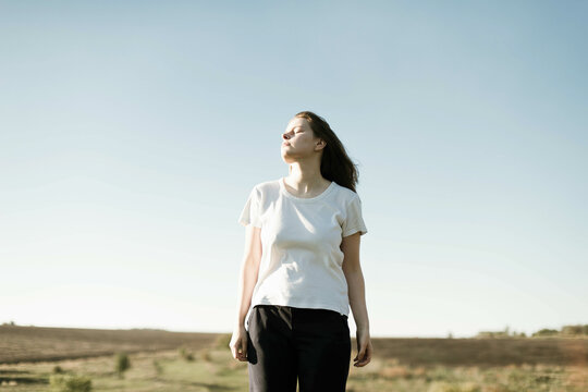 Dreamy portrait of a young brunette woman outdoor