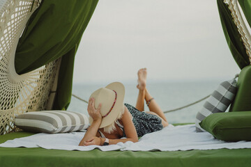 Woman in a pavilion on the seashore, vacation.