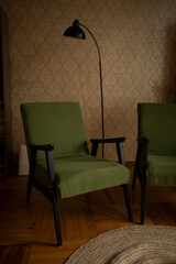 a seaworthy armchair with green upholstery and wooden planks in the interior of the living room. two green armchairs in the room