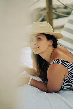 Woman working on laptop on vacation, on the beach, freelancer.