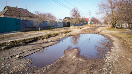 A puddle on the road in the village