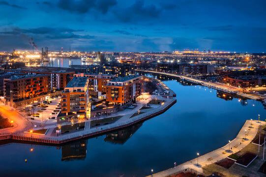Gdansk city by the Motlawa river with the harbour area at dusk, Poland.