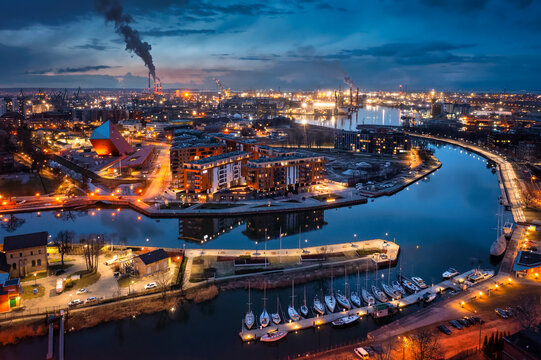 Gdansk city by the Motlawa river with the harbour area at dusk, Poland.