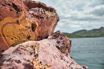 Close-up of a deep pink rock in Komodo National Park on Flores, diffuse background.