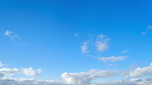 Cumulus clouds are moving forward, timelapse. Blue sky with white cumulus clouds are coming