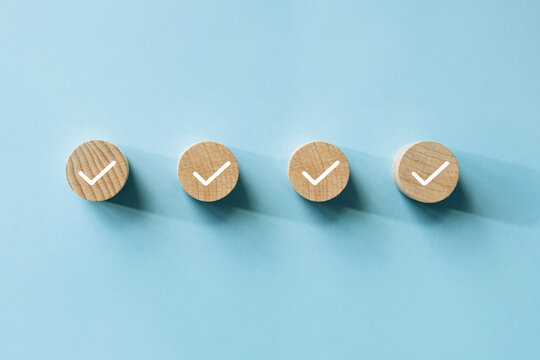 Checklist concept, Check mark on wooden blocks, blue background with copy space