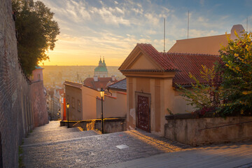 beautiful view of new castle stairs in the old town with a historic street lamp in the glow of the sunrise