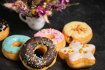 Obraz na płótnie Canvas assorted donuts cake on a dark background