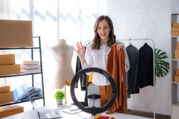 Owner woman is doing a live broadcast selling clothe.