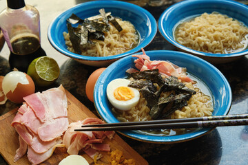 ramen soup in plates ingredients on the table