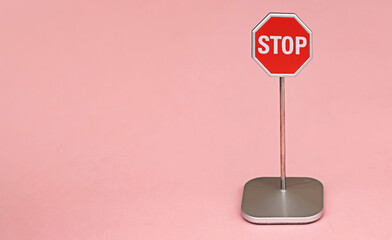 Red stop sign, traffic warning octagon pink background with copy space for your text or...