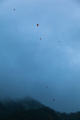 Flying Symbol of Hopes / Floating sky lanterns at rainy clouds background over hills landscape of Shifen, Taiwan (copy space)