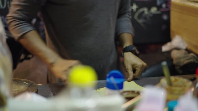 Unrecognizable thai man hands preparing a rotee dough