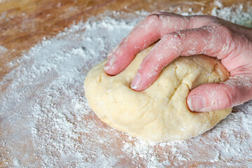 Woman's hand knead raw dough