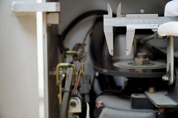 mechanic uses a vernier to check the thickness of the forklift brake discs,forklift service concept